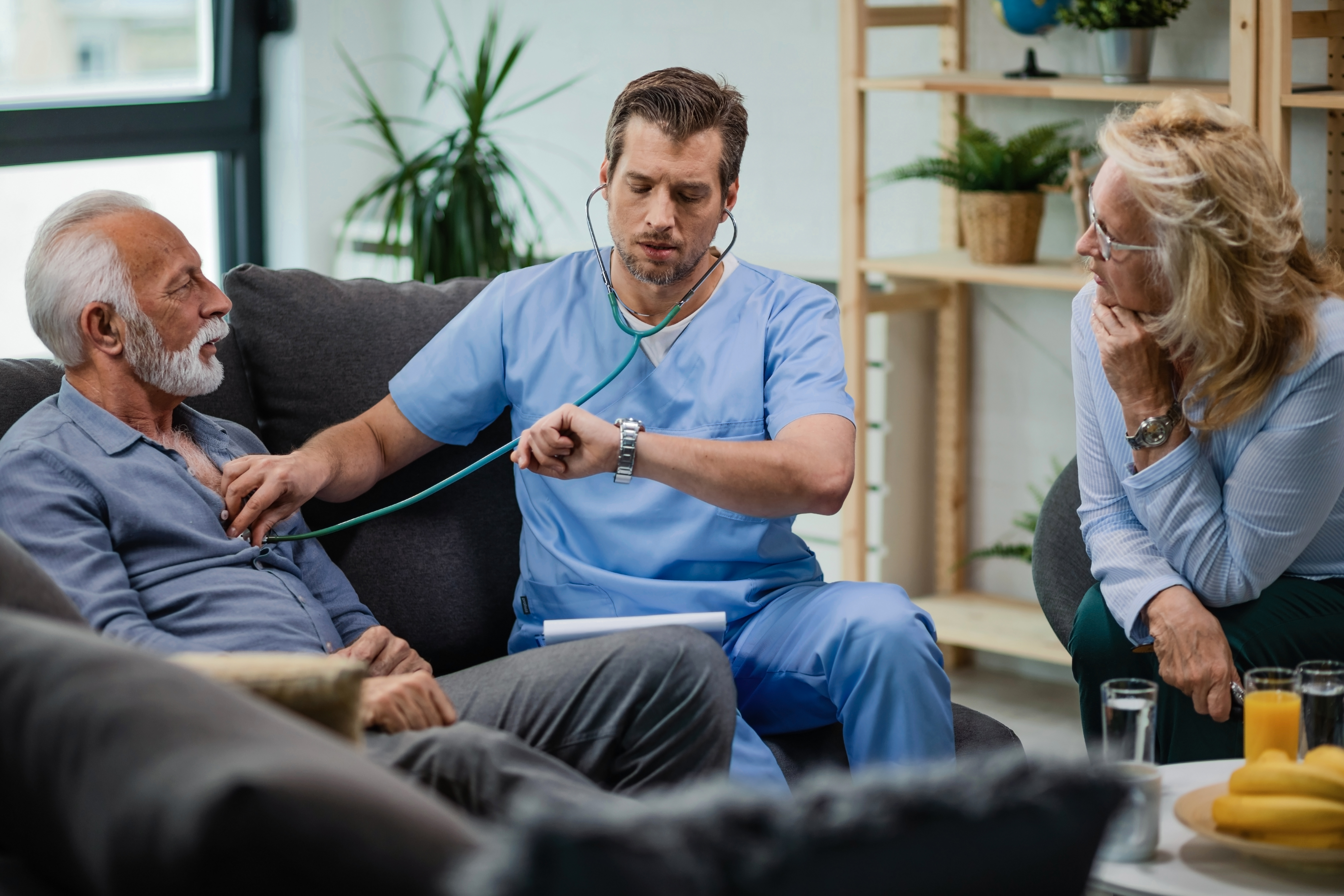 Caregiver assisting a patient recovering from surgery at home